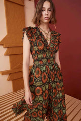 Close-up of the green and orange patterned metallic jacquard fabric on the dress.