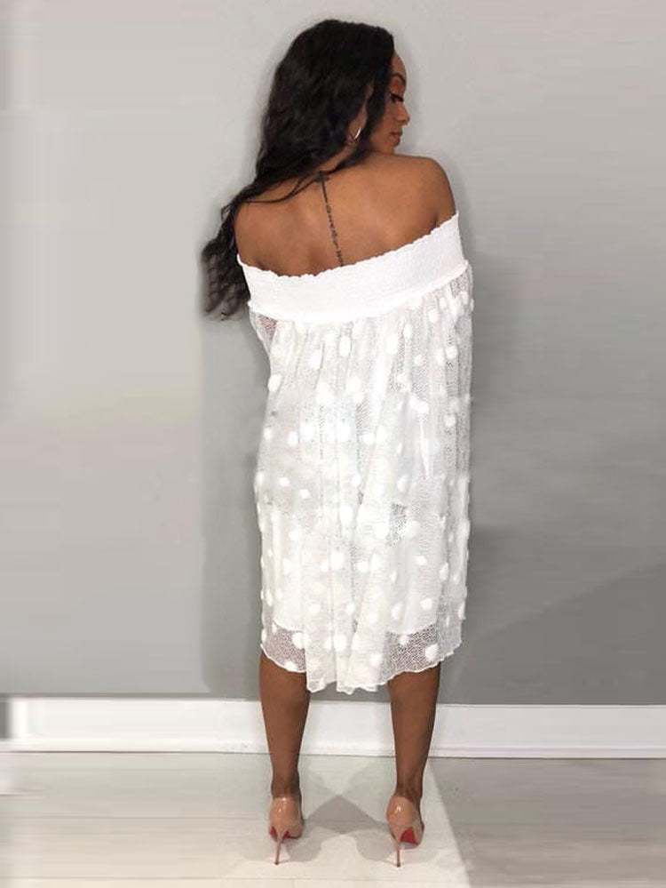 Back view of a woman in a white off-the-shoulder polka dot dress