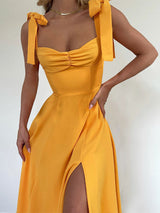 Close-up of a yellow dress with ruched bodice and tie shoulder straps
