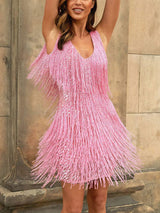 Woman wearing a pink sequined dress with fringe detailing, front view