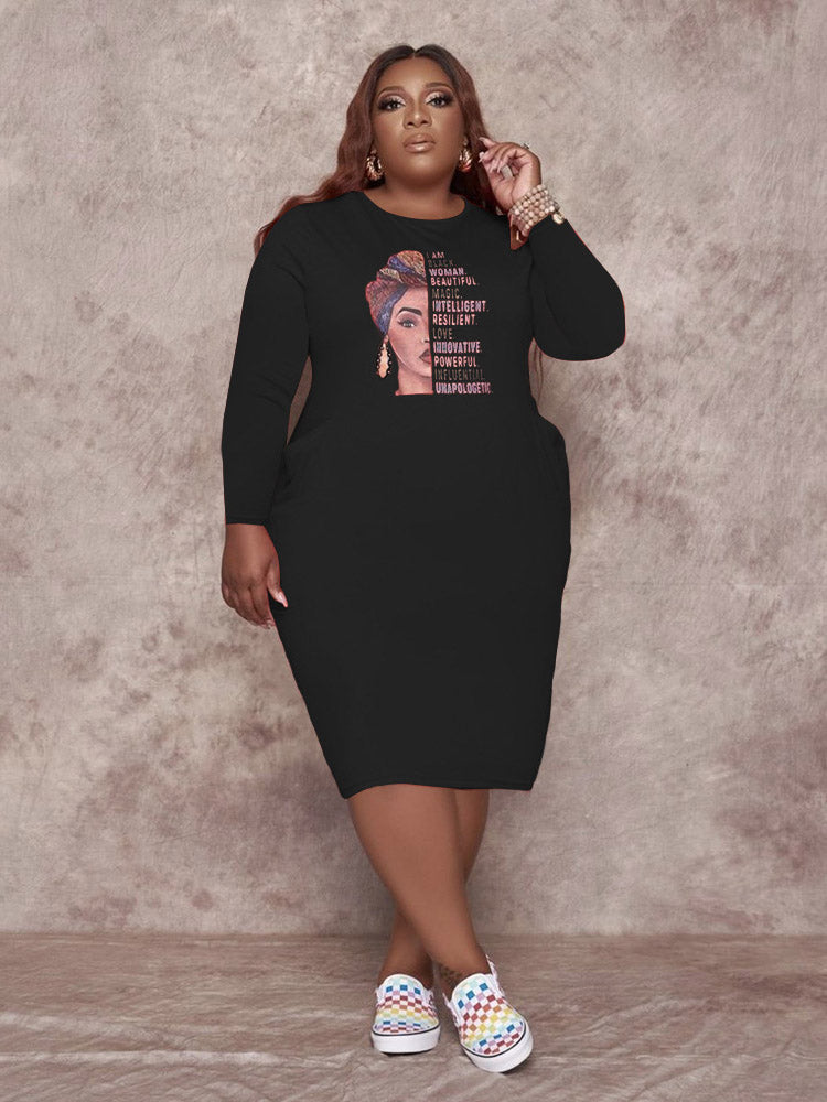 Black long-sleeved t-shirt dress with a graphic print of a woman and empowering text, worn by a plus-size model.