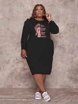 Black long-sleeved t-shirt dress with a graphic print of a woman and empowering text, worn by a plus-size model.
