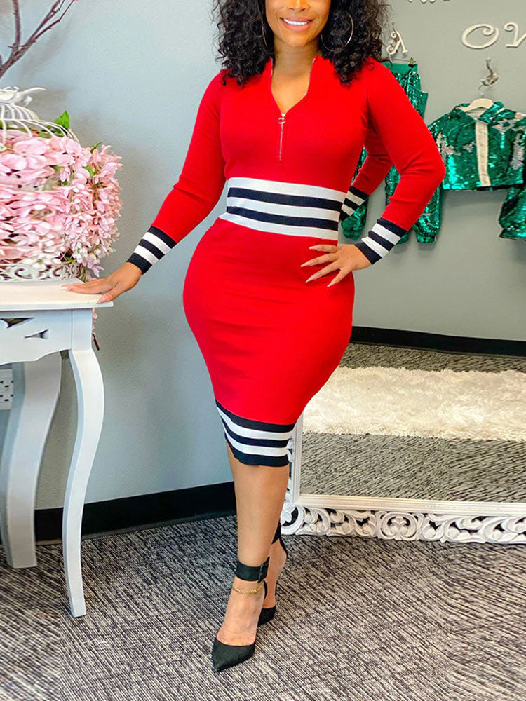 Woman in a red long-sleeved knit dress with black and white stripes
