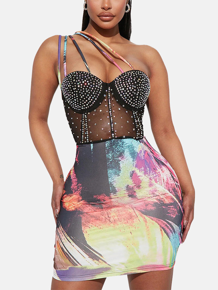 Close-up of a black mesh dress bodice with rhinestone embellishments and colorful abstract print skirt