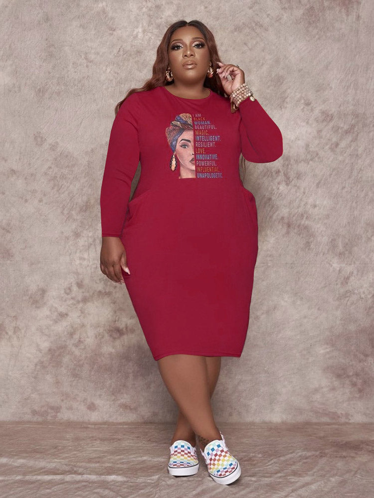 Maroon long-sleeved t-shirt dress with a graphic print of a woman and empowering text, worn by a plus-size model.