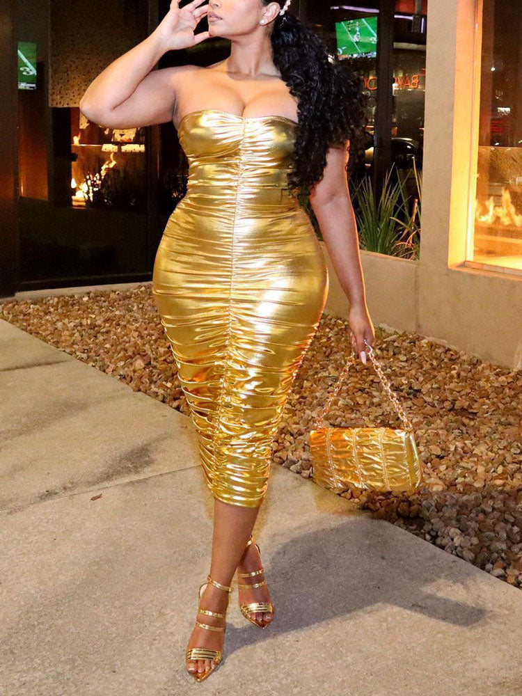 woman in a gold ruched strapless midi dress from the side