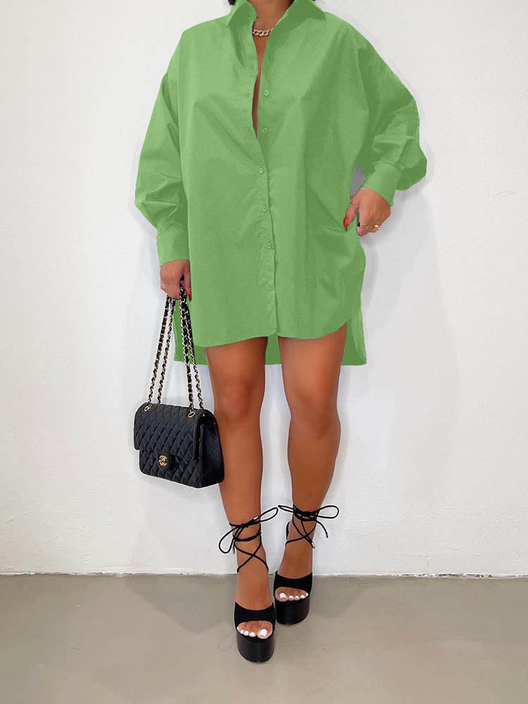Woman wearing an oversized lime green collared shirt dress with a high-low hemline, paired with black platform heels and a black quilted handbag.