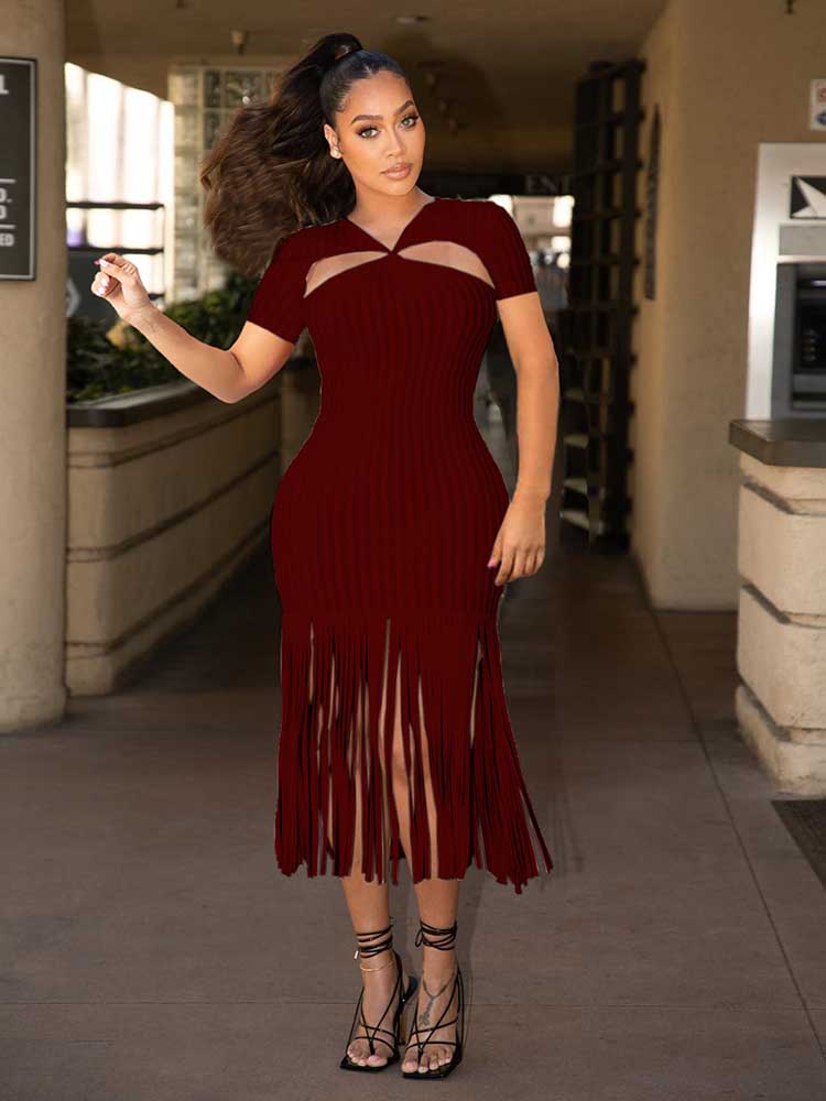 woman wearing a burgundy ribbed knit midi dress with cut-out neckline and fringe hem