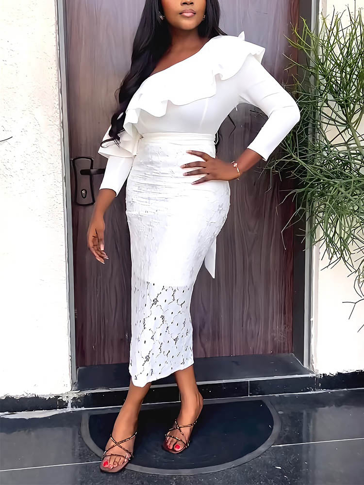 Woman wearing a white one-shoulder dress with ruffle detail and lace skirt, posing with hand on hip.