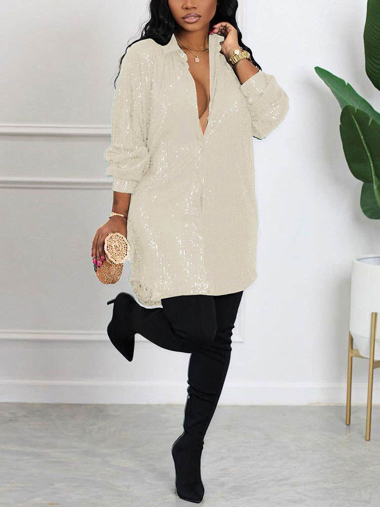 woman wearing an off-white sequin shirt dress with black thigh-high boots and a gold clutch