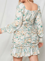 Back view of a woman in a light blue floral print off-the-shoulder ruched mini dress with long balloon sleeves.