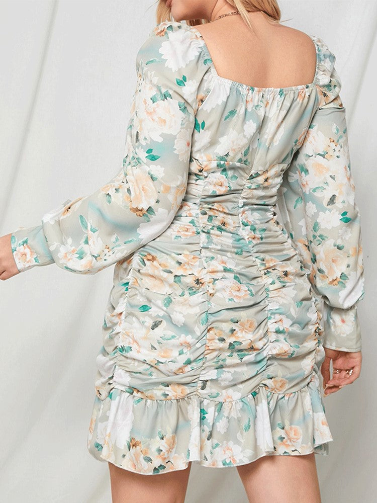 Back view of a woman in a light blue floral print off-the-shoulder ruched mini dress with long balloon sleeves.