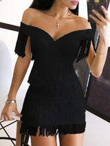 Woman modeling a white dress with fringe accents.