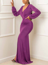 woman wearing a long purple ruched maxi dress with a v-neck and high slit