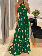 Woman wearing a green maxi dress with a polka dot print