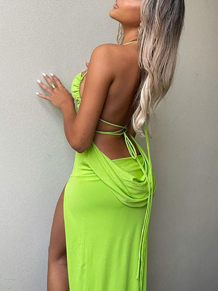 Back view of a woman in a lime green maxi dress with an open back and draping detail