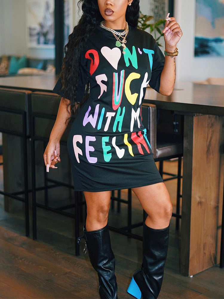 Close-up of the graphic print on a black t-shirt dress.