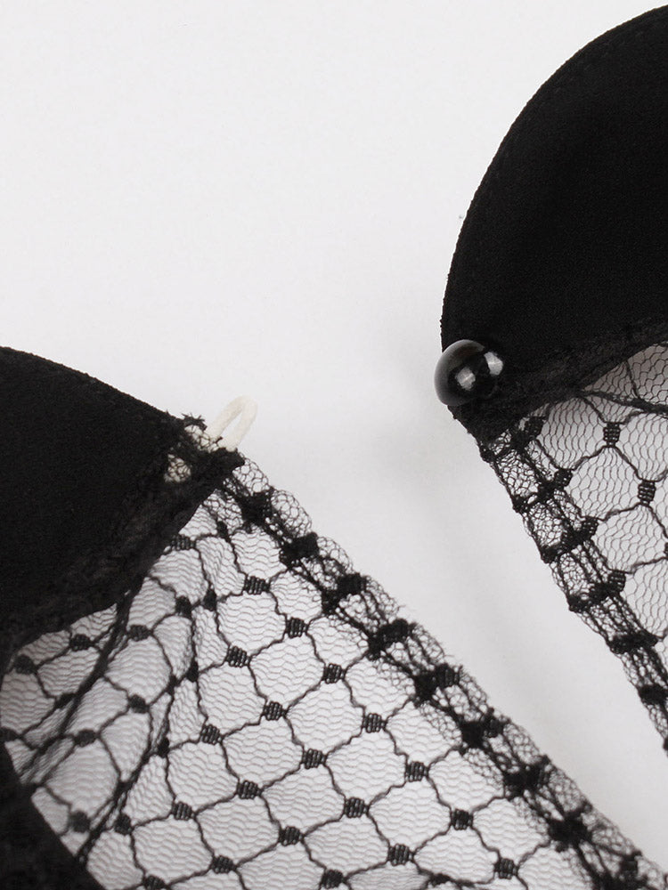 close-up of the black mesh overlay and black bead closure on the dress