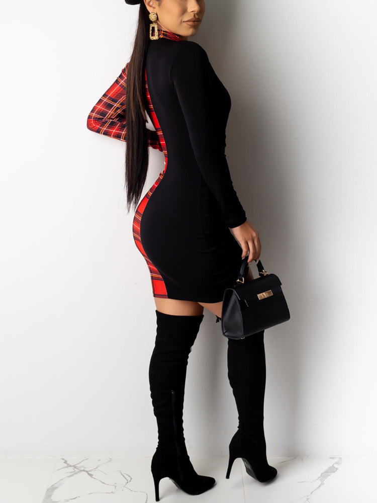 Side view of a woman wearing a black and red plaid long sleeve mini dress with ruched detailing and a deep V-neckline, paired with black knee-high boots and a black handbag.