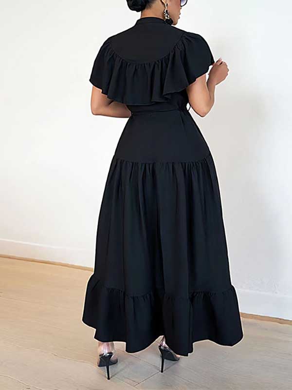 Rear view of a woman in a black ruffled midi dress, showing the tiered hem.