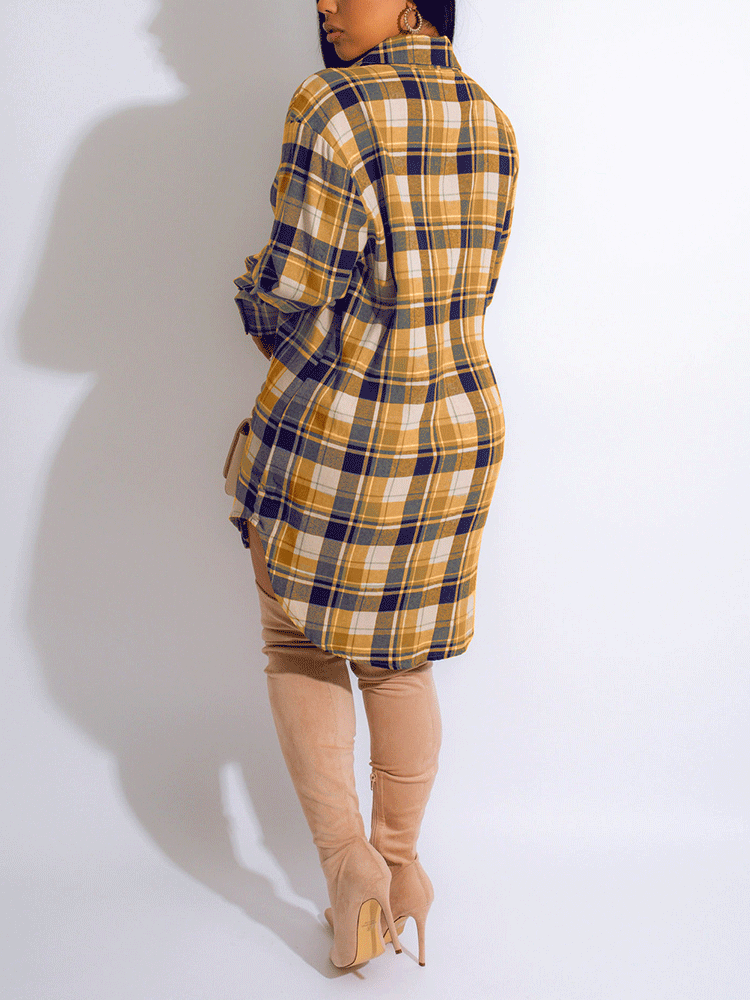 Woman wearing a yellow and navy plaid shirt dress with thigh-high beige boots, back view.