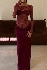 Woman in a long burgundy lace dress posing in front of a sofa, showing a mirror reflection.
