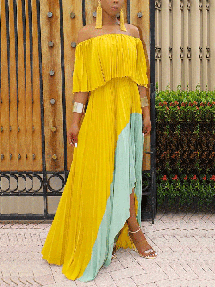 Full shot of a woman in a yellow and mint green pleated maxi dress