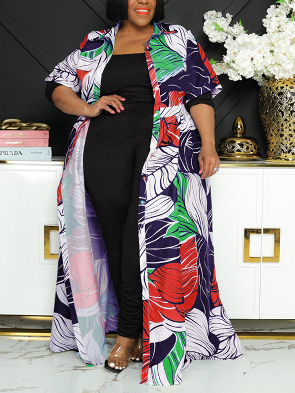 Woman wearing a floral print duster over a black jumpsuit.