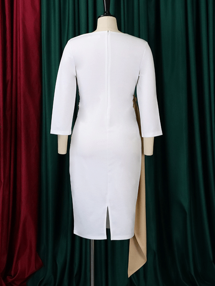 Back view of a white sheath dress with a tan ruched sash and tie detail on a mannequin, showing the back zipper and slit.