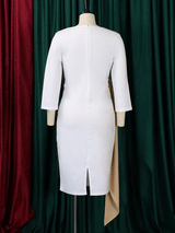Back view of a white sheath dress with a tan ruched sash and tie detail on a mannequin, showing the back zipper and slit.