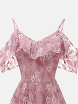 Close-up of the neckline and cold shoulder detail on a pink lace dress