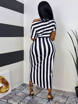 Back view of a woman wearing a black and white striped off-the-shoulder dress