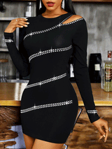 Close-up of the asymmetrical neckline and rhinestone detailing on the black dress.
