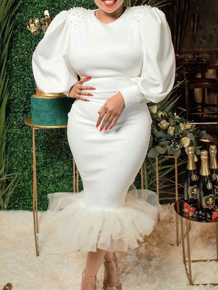 Woman in white puff sleeve dress with ruffled hem