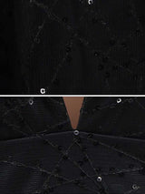 Close-up of the black fabric of the gown, showing the geometric pattern and sequin embellishments.