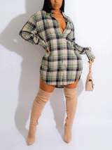 Woman wearing a green and black plaid shirt dress with thigh-high beige boots and a light beige handbag, front view.