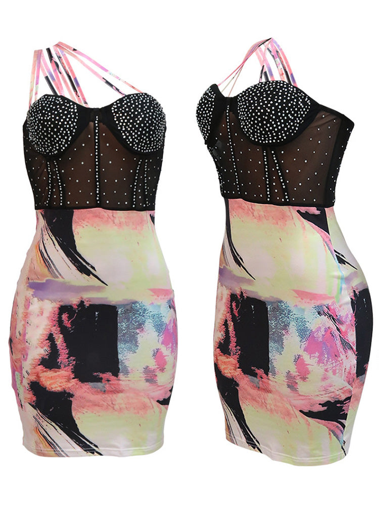 Front and side views of a black mesh dress with rhinestone embellishments and a colorful abstract print skirt