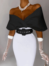 Woman wearing a black off-the-shoulder top with a white pencil skirt, a black belt, white sheer gloves, and pearl necklace.
