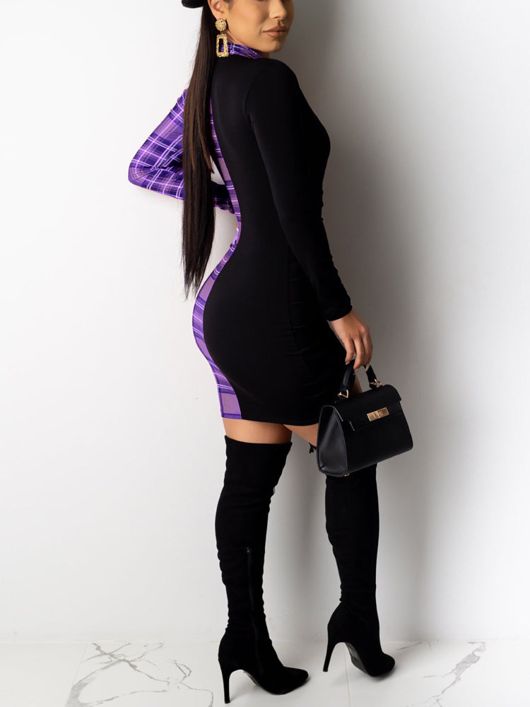 Side view of a woman wearing a black and purple plaid long sleeve mini dress with ruched detailing and a deep V-neckline, paired with black knee-high boots and a black handbag.
