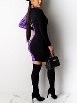 Side view of a woman wearing a black and purple plaid long sleeve mini dress with ruched detailing and a deep V-neckline, paired with black knee-high boots and a black handbag.
