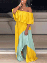 Woman posing in a yellow and mint green off-the-shoulder pleated maxi dress