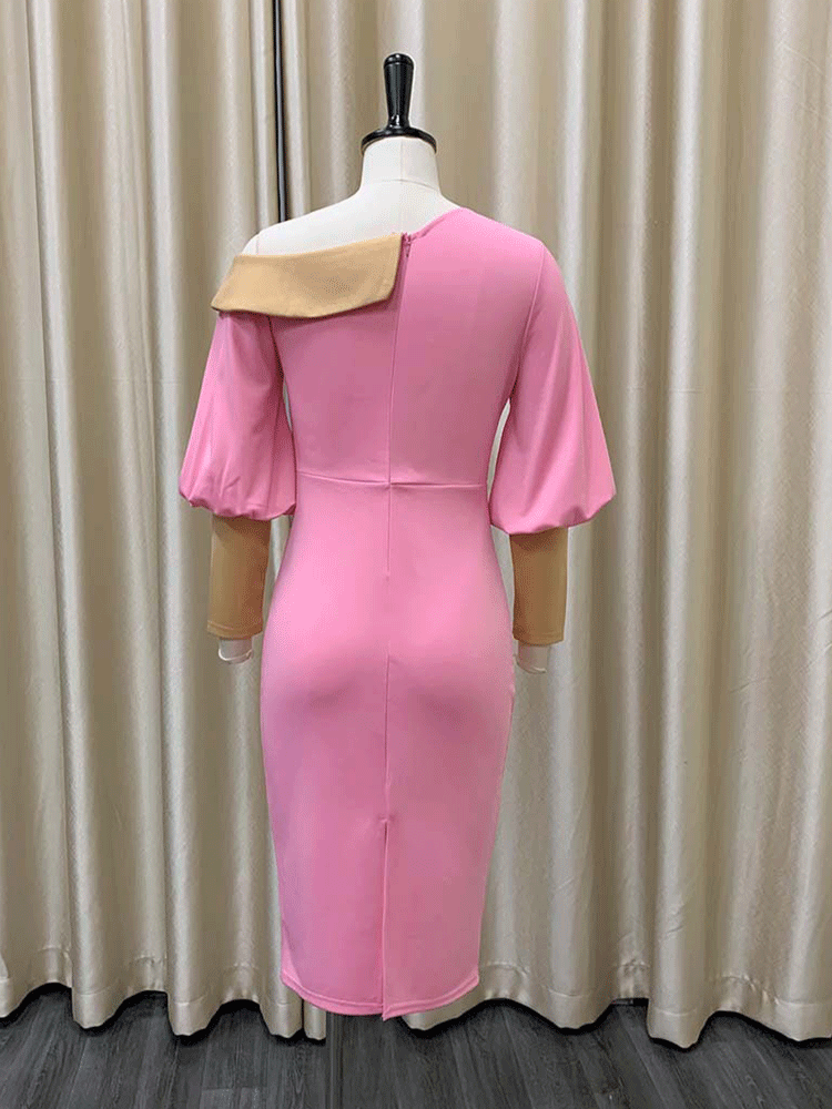 back view of pink sheath dress with asymmetrical neckline and balloon sleeves displayed on a mannequin