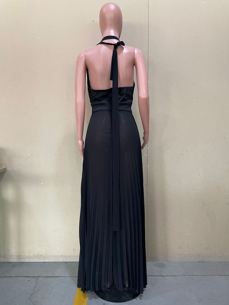 Mannequin displaying the back of a black halter maxi dress with a tie closure and pleated skirt.