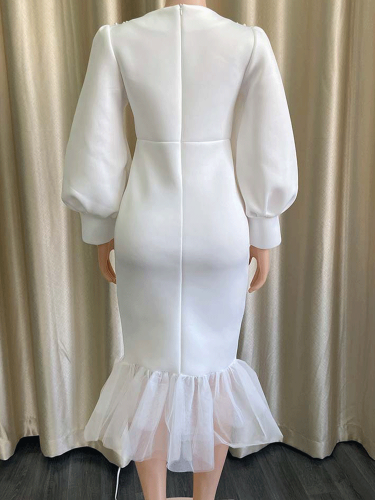 Back view of white puff sleeve dress on mannequin