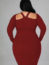 Rear view of a woman wearing a burgundy long-sleeved ribbed knit bodycon dress with a cutout neckline.