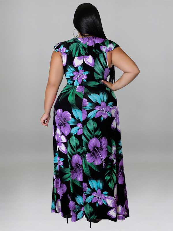 Rear view of a woman wearing a black maxi dress with a purple and green floral print.