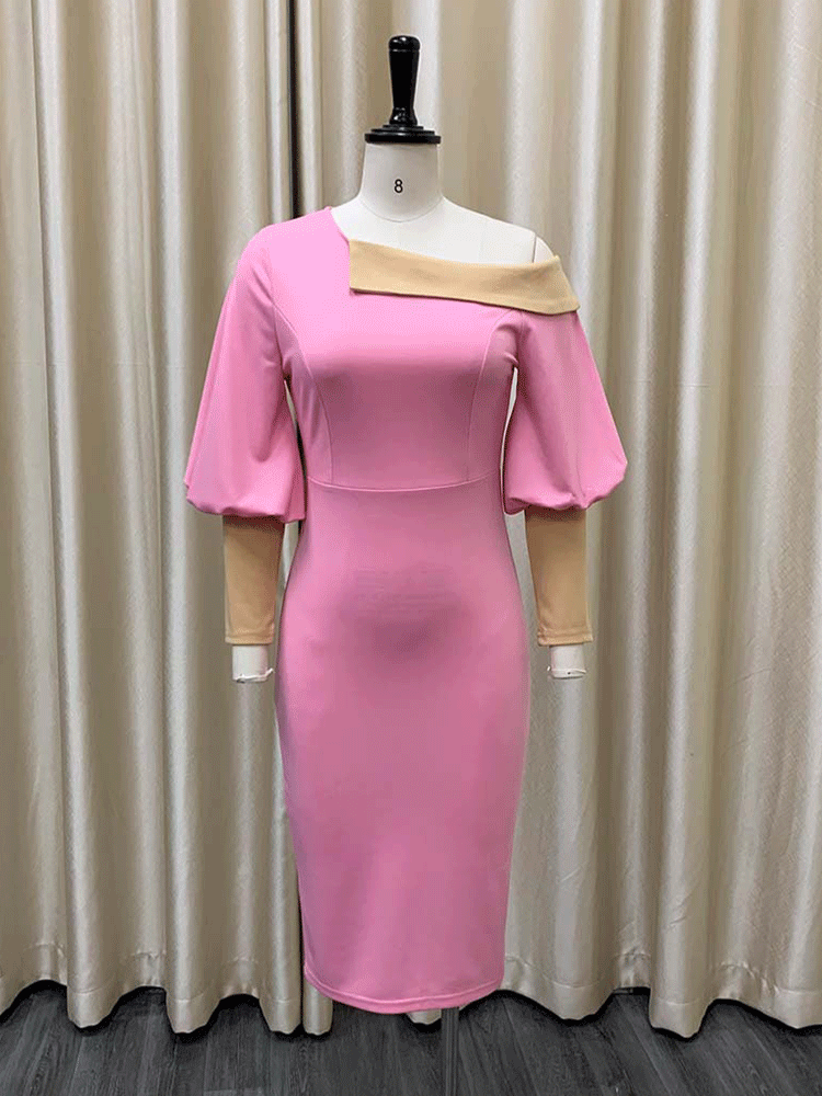 pink sheath dress with asymmetrical neckline and balloon sleeves displayed on a mannequin