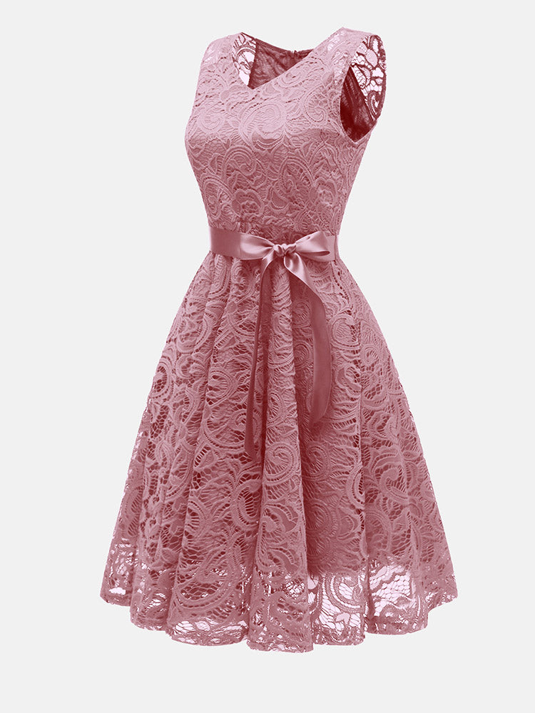 Side view of pink lace fit and flare dress with V-neck and satin ribbon