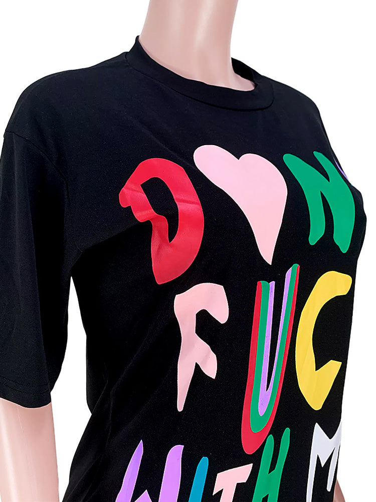 Close-up of the graphic print on a black t-shirt dress.