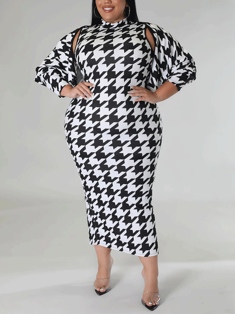 Plus size model wearing a black and white houndstooth print mock neck midi dress and a matching jacket with cut-out shoulders